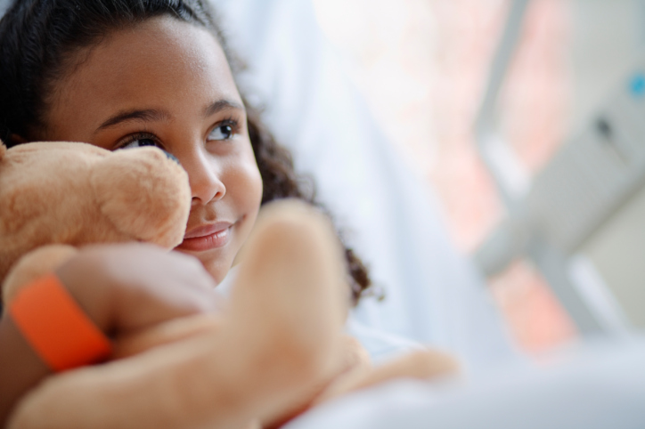 Young girl smiling in hospital bed