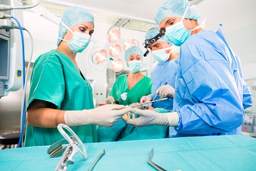 Surgeons in scrubs perform surgery in an operating room