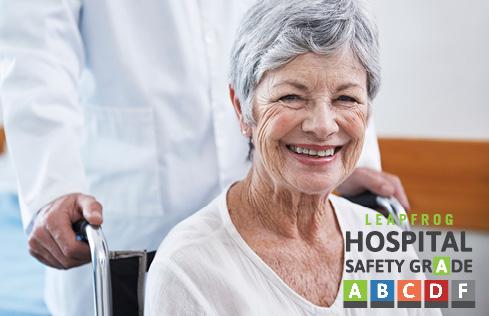 A woman smiling in a wheelchair, with Leapfrog Hospital Safety Grade icons visible.